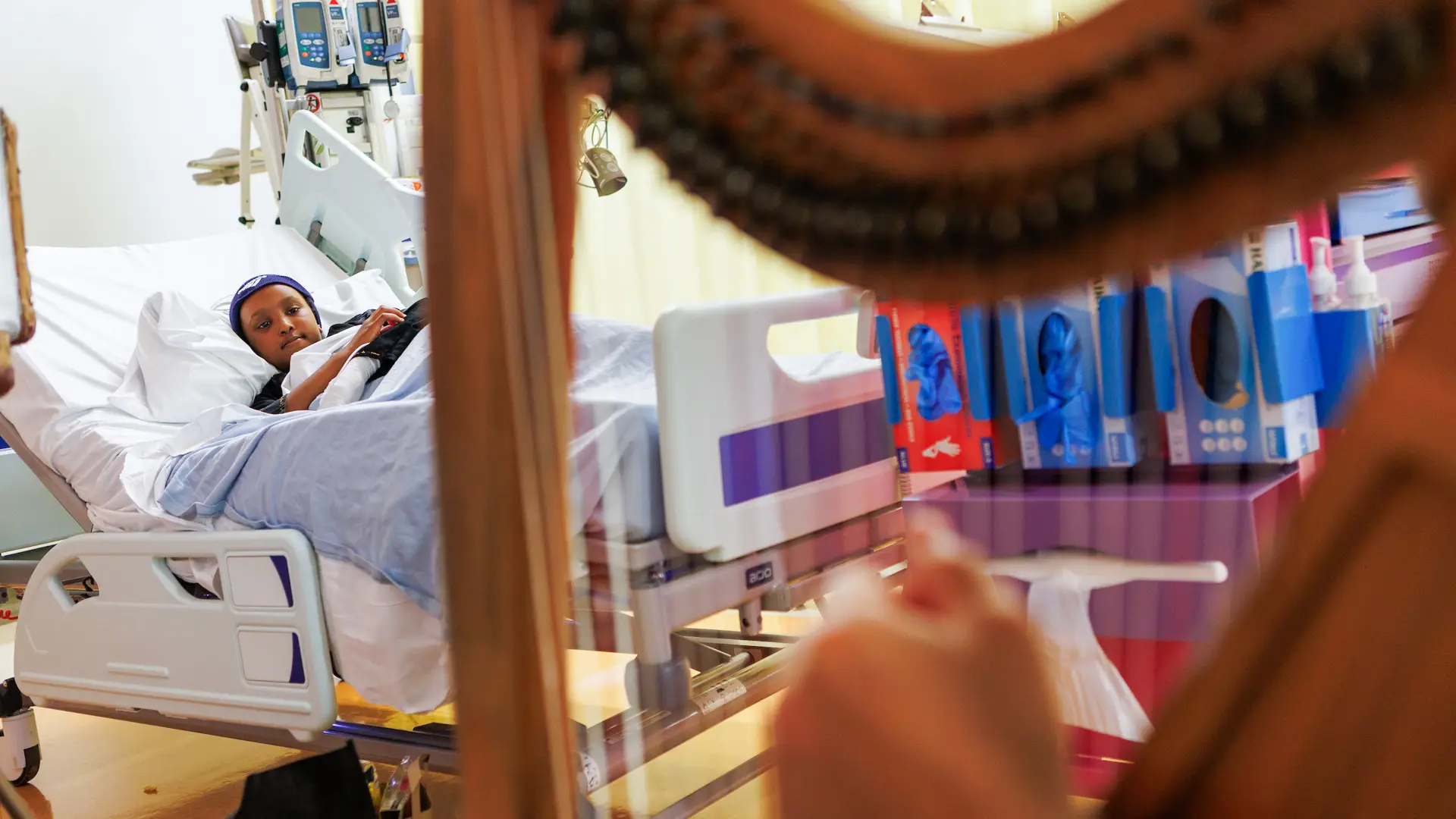 A harp and shadow puppet performance for a young patient on the ward at Chelsea and Westminster hospital.