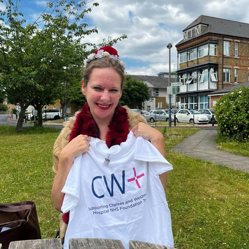Amber Hicks, staff member, holding a CW+ T-shirt