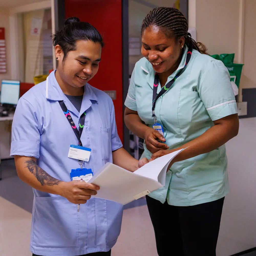 Two members of hospital talking on the ward at Chelsea and Westminster Hospital