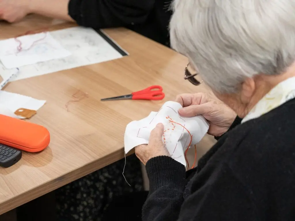 A woman doing some needle craft