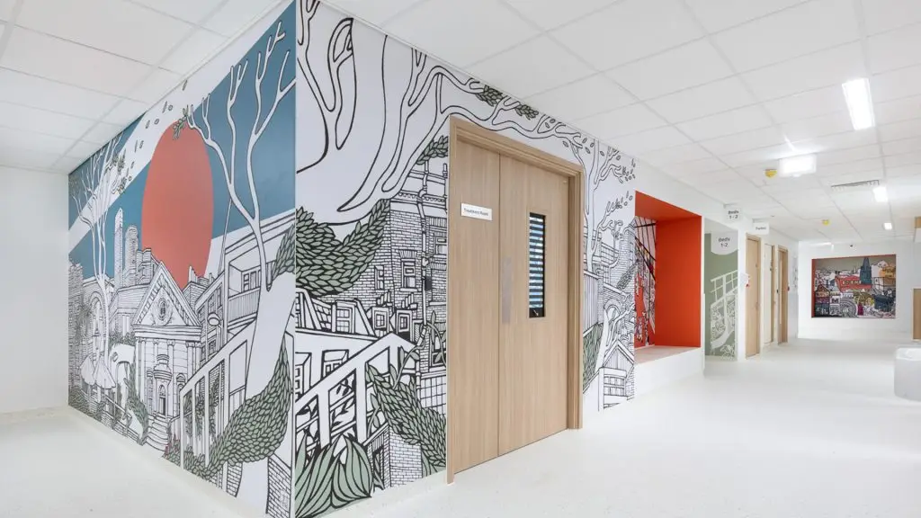 Reuben Young People's Centre – a corridor with vibrant murals of citscapes on the walls