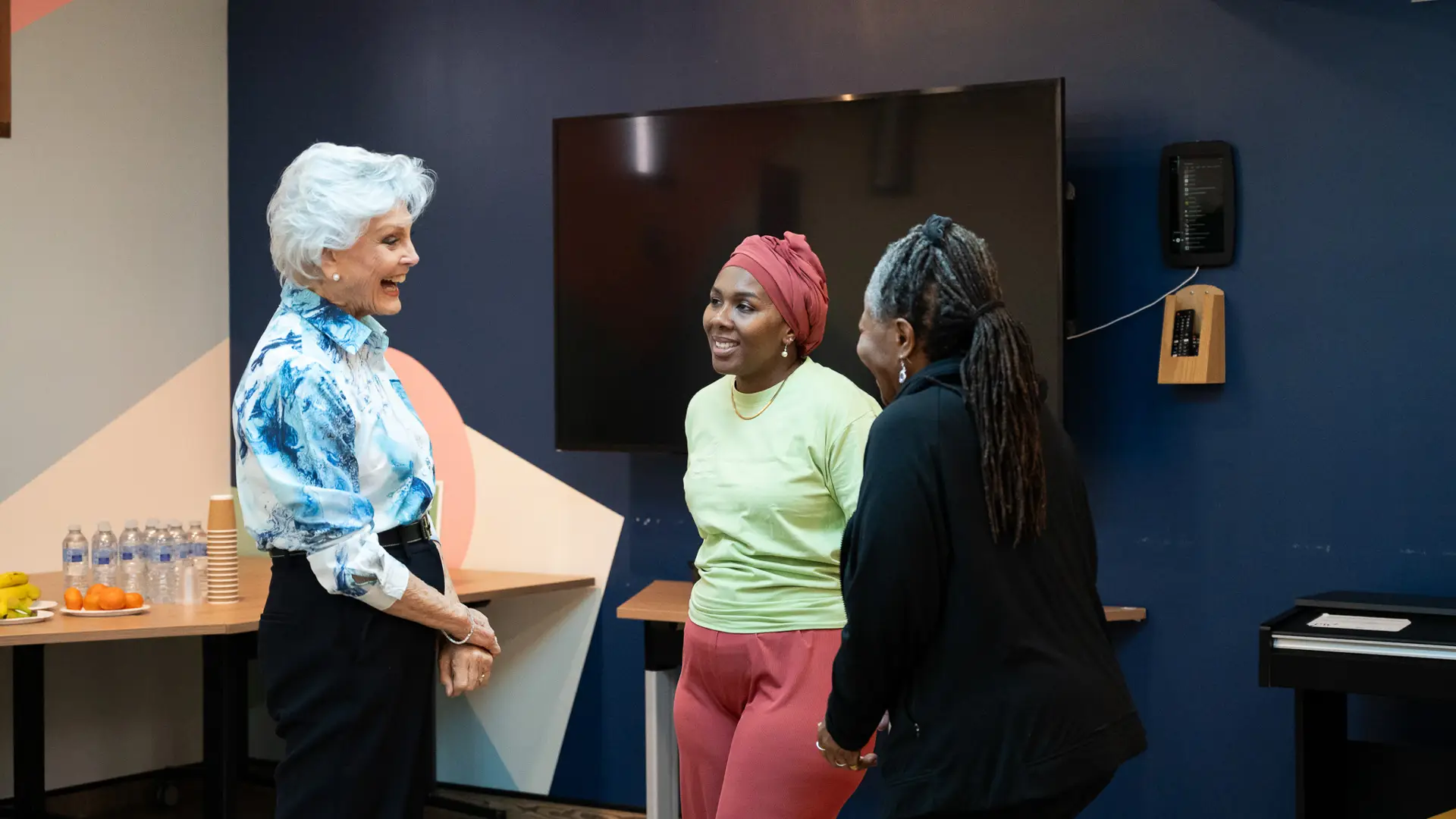Angela Rippon chatting to two women in the CW+ Studio at Chelsea and Westminster Hospital