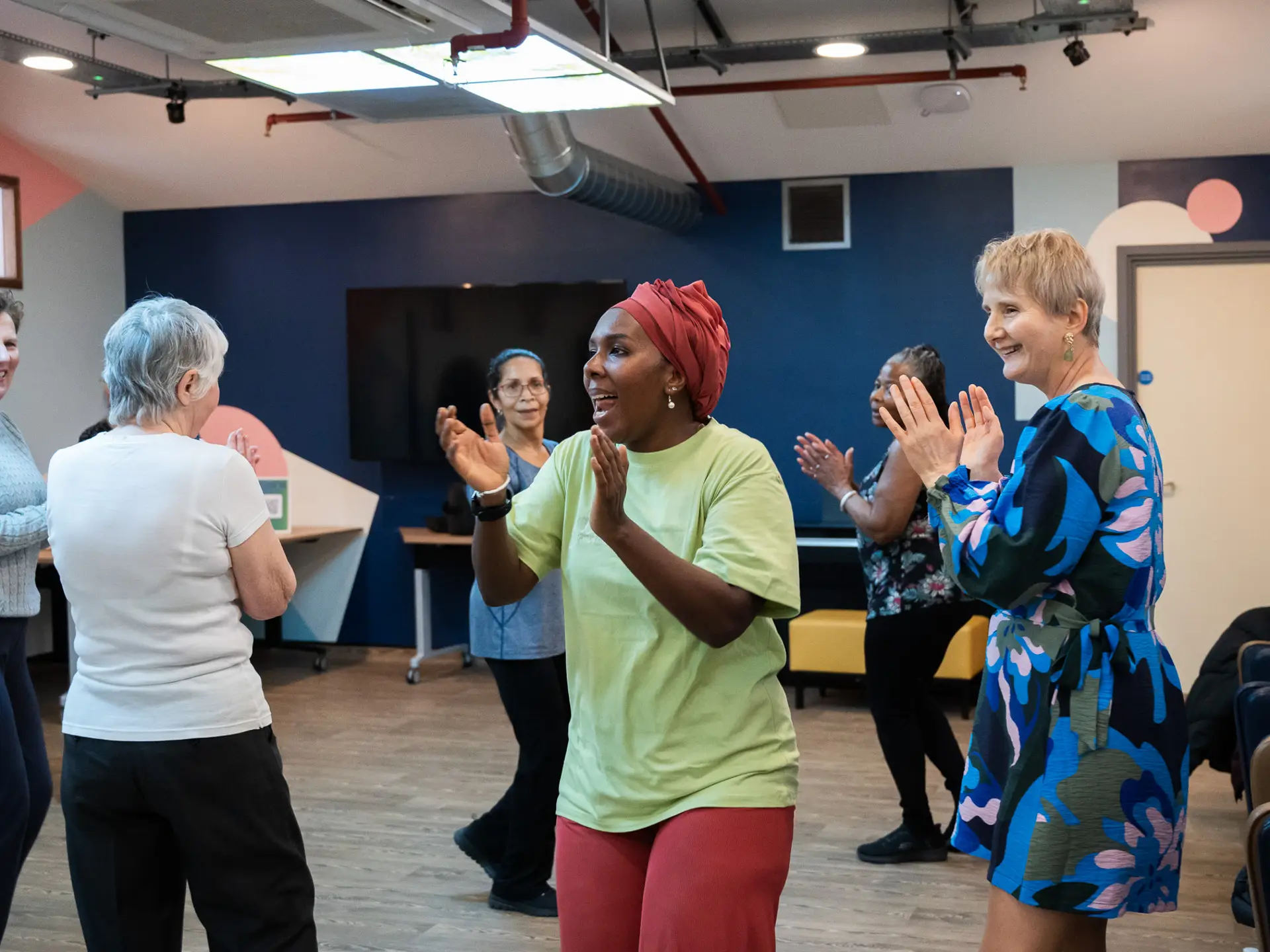 People dancing and clapping in a circle format