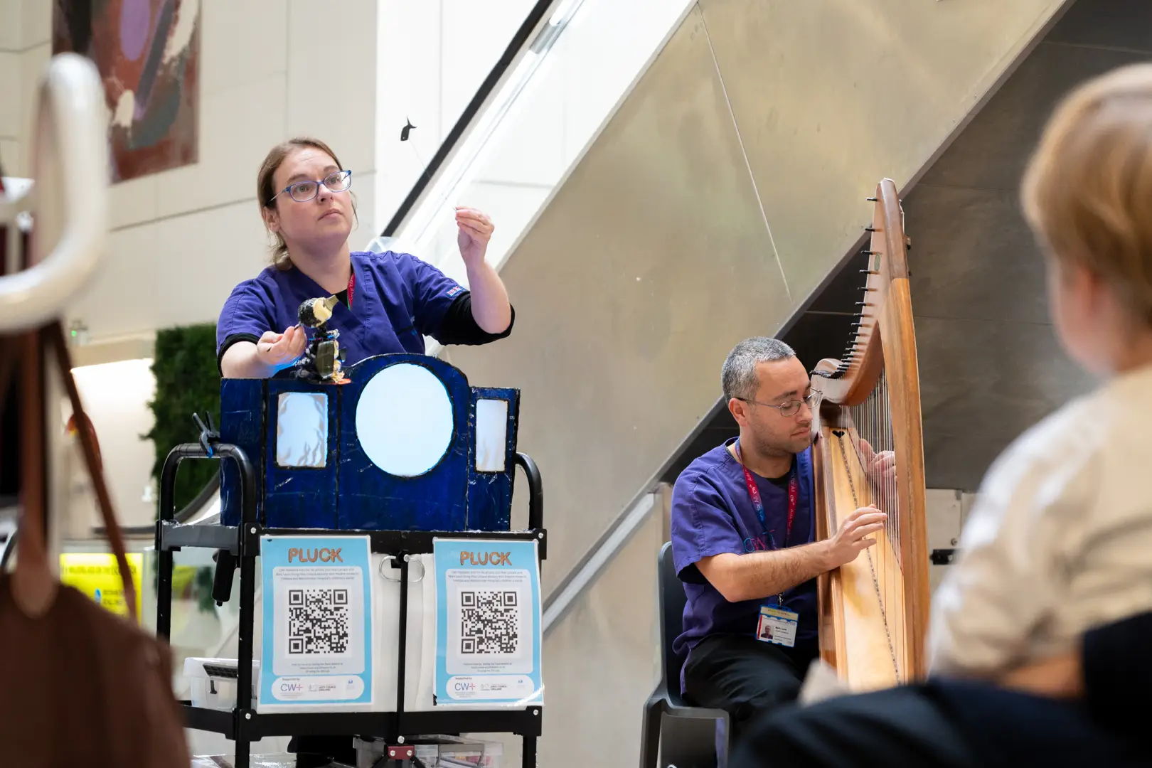 A puppeteer and harpist perform to a child at Chelsea and Westminster Hospital as part of the CW+ Arts for All programme, which aims to improve patient experience by providing access to music, performance and creative activities.