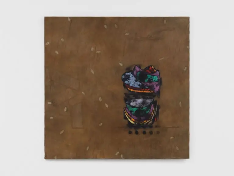 A brown-toned abstract painting with a small, layered, multicoloured form near the lower right, surrounded by scattered pale oval shapes.